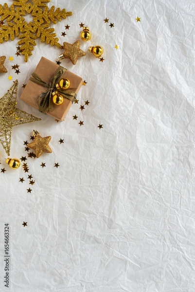 Fototapeta Gold Christmas theme decorations on paper texture background,  Christmas tree, gold presents box, decorative gold stars and gold gift box.