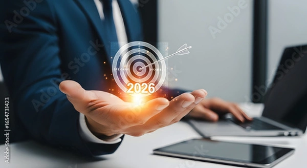 Fototapeta Businessman holding a glowing digital target with data connections
