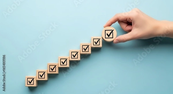 Fototapeta Hand Completes Checkbox Tower Representing Success and Achievement