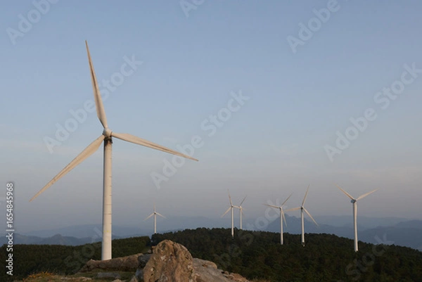 Fototapeta A panoramic view of multiple wind turbines on the Oiz mountains, Bizkaia, Spain. Clean energy production surrounded by nature.