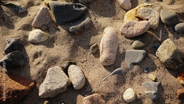 Fototapeta rocks in the sand as a background