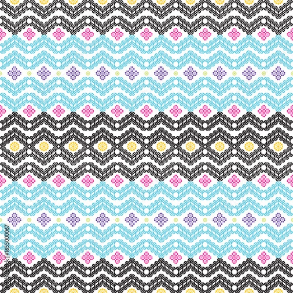 Fototapeta Seamless geometric ethnic pattern with colorful ornamental zigzag design in black, blue, yellow, pink, and purple. Perfect for textile, wallpaper, wrapping paper, bohemian decor and digital background