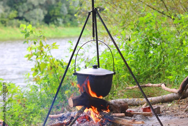 Obraz Camping pot over smoldering fire