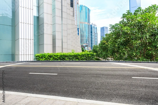 Fototapeta empty asphalt road and modern buildings in shanghai,china.