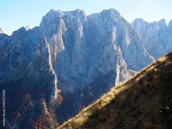 Obraz Mountain range of Prokletije National Park, Montenegro. Golden autumn in the mountains on a sunny day. Hike to Volushnica mountain.