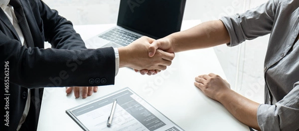 Fototapeta Good deal of interview, Business people and recruiter shaking hands greeting or get acquainted of conducting a job interview while sitting at the working meeting in office