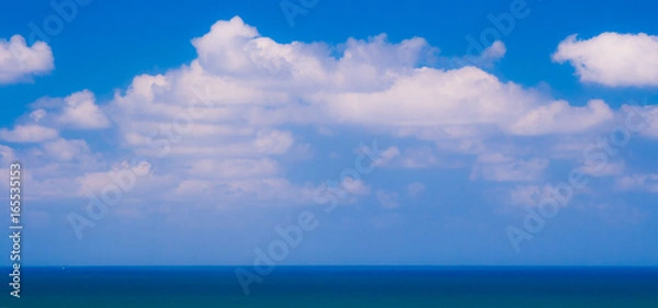 Obraz Ocean blue with white clouds above