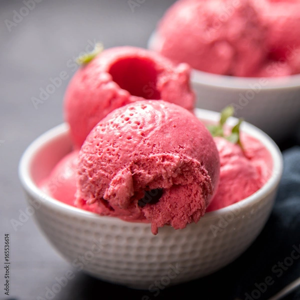Fototapeta Ice cream Raspberry  in white bowl on the black background.Dessert.Copy space for Text.Sorbet In the form of a ball.selective focus.