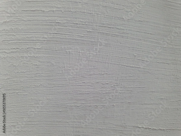 Fototapeta The color is a neutral light gray or off-white, with subtle variations and a rough, tactile feel. The pattern is organic and hand-painted.