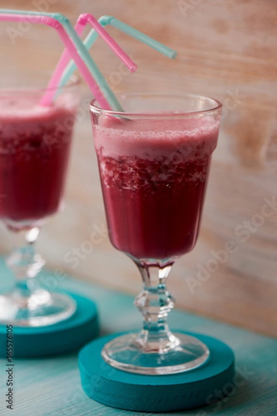Fototapeta Fresh cool smoothie in a glass with a stem. Delicious and healthy Breakfast. Of cherries and strawberries