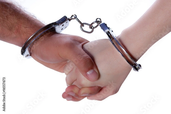 Fototapeta Man and Woman hands with handcuffs
