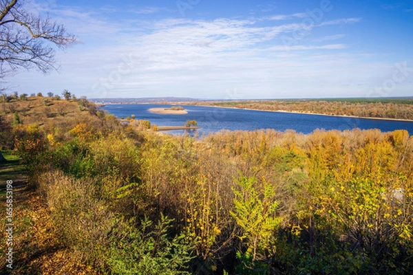 Fototapeta Scenic autumn landscape showing the Dnieper river flowing near the Taras Shevchenko Grave, located on Chernecha Hill in Kaniv, Ukraine, under a beautiful blue sky