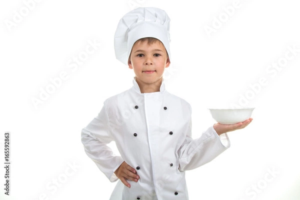 Obraz A kid with an empty plate on his hand wearing chef uniform, isolated on white background.
