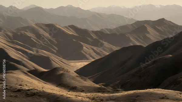 Fototapeta view of layered hills fading into the distance under soft morning haze