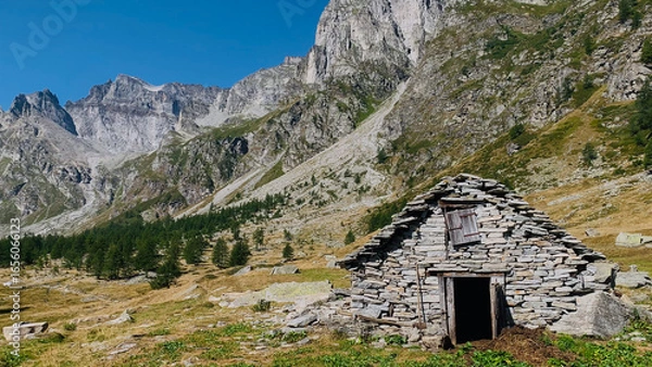 Fototapeta Beautiful mountain landscape with a traditional mountain hut with piode or beole, the local term for stone slab roofs in the Alpe Devero National Park, Piedmont, Italy