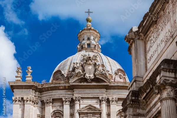 Fototapeta Ancient Roman and Baroque architecture in Rome. Saints Luca and Martina beautiful dome and lantern, built in the 17th century, with ancient roman ruins