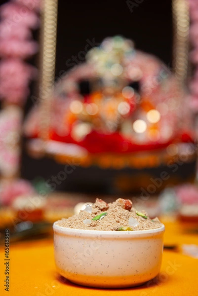 Fototapeta Devotional Food Offering Prasad Bowl with Krishna Janmashtami Idol