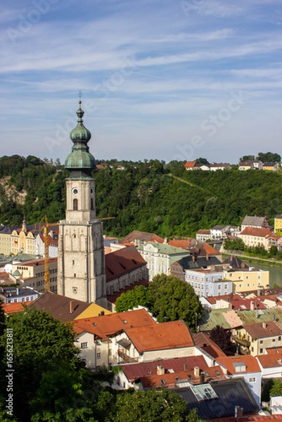 Obraz Church tower with green dome roof and clock in Burghausen, Bavaria, Germany, overlooking the river and colorful old town houses, photographed in 2024.