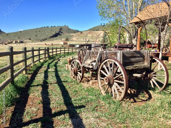 Obraz Vintage antique covered wagon in American prairie grassland