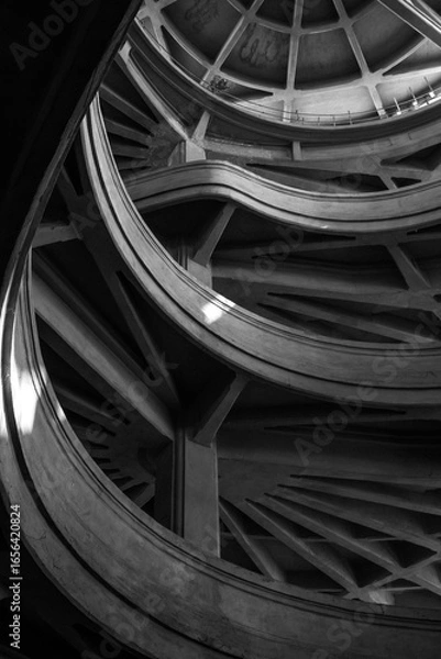 Obraz Monochrome image showcasing intricate curves and geometric design of a modern concrete structure.