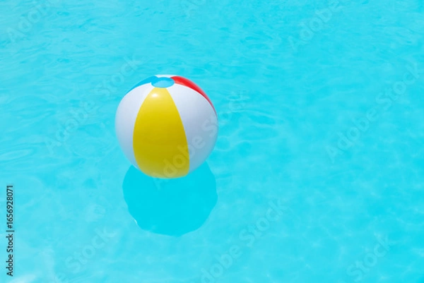 Obraz Beach Ball Floating on water surface of a swimming pool. Summer background. Copy space