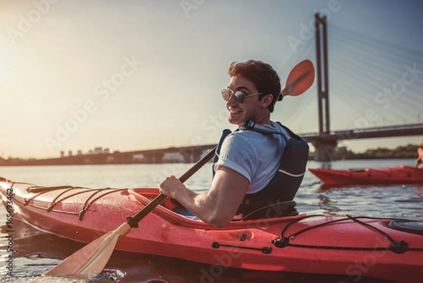 Fototapeta Man kayaking on sunset