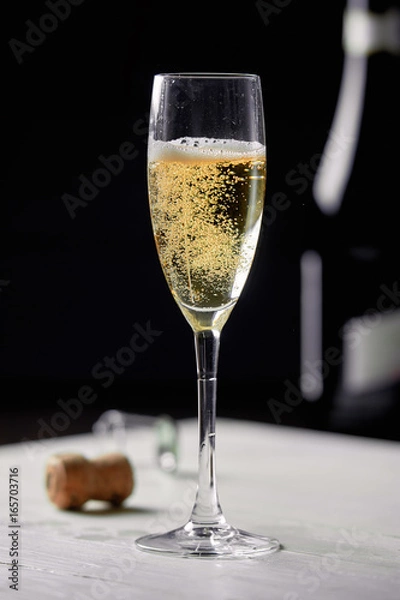 Obraz A glass of champagne on a black background