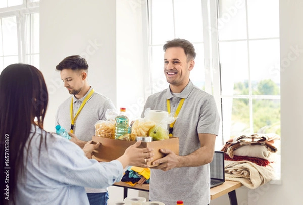 Fototapeta Food box giving, diverse caring volunteer group working in charitable food foundation, make donation to needy, charity, separating donations stuff, food bank stocks, basic need provisions, free meal