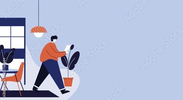 Fototapeta A man walks and reads a document in a bright, modern interior, illustrating remote work, learning, and productive lifestyle.