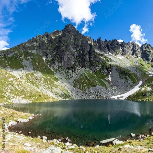 Fototapeta Mountain lake reflecting sky