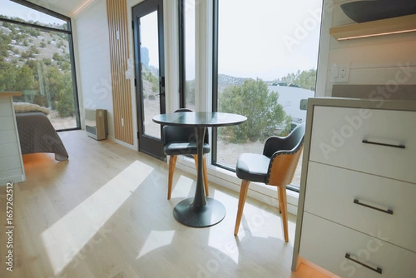 Obraz Cozy dining area with modern furniture and scenic views of nature