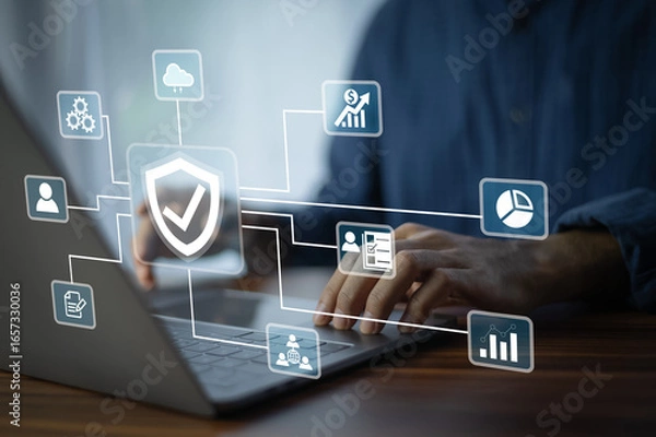 Fototapeta A business analyst working on a laptop monitors network security dashboards to detect risks in real time. Security for Business data and Protection.