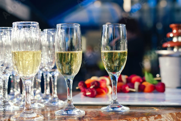 Fototapeta Glasses of champagne on table served for buffet catering party outdoors. Cocktail in Wedding, fair, seminar, meeting, conference and background, selective focus and blur background.