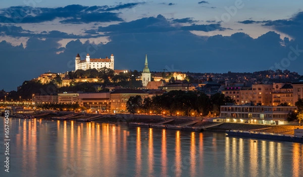 Obraz Bratislava castle at night with light reflection on the dunaj river on right riverside.