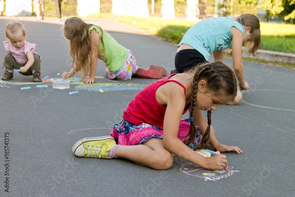 Obraz Kids absorbedly draw chalks on the pavement