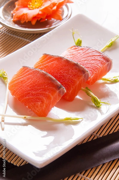 Obraz salmon sashimi on white dish on table background