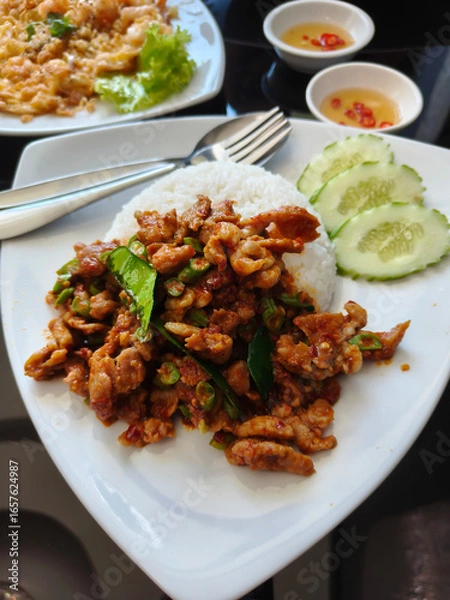 Fototapeta Pork fried rice with curry paste looks delicious and spicy.