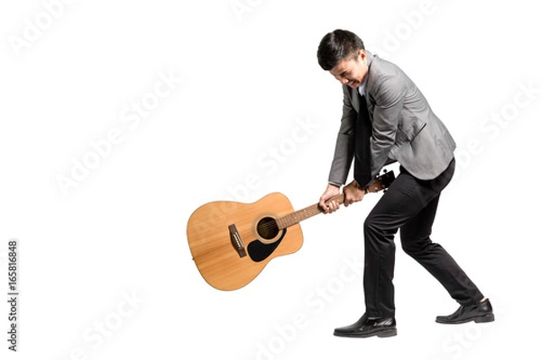 Obraz Portrait of a young business man smashing his guitar. Isolated on white background with copy space and clipping path