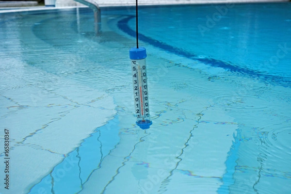 Fototapeta A thermometer immersed in water in the pool