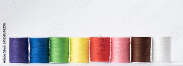Obraz Colorful sewing threads isolated on white background