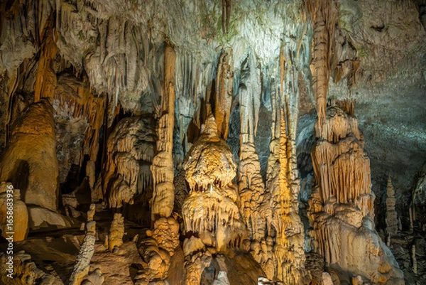 Obraz Postojna cave illuminated stalagmites and stalactites
