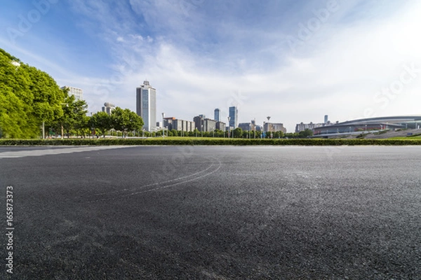 Fototapeta Panoramic skyline and buildings with empty road