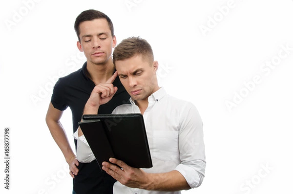 Fototapeta Two serious guys are working on the project. Tablet and technology.
