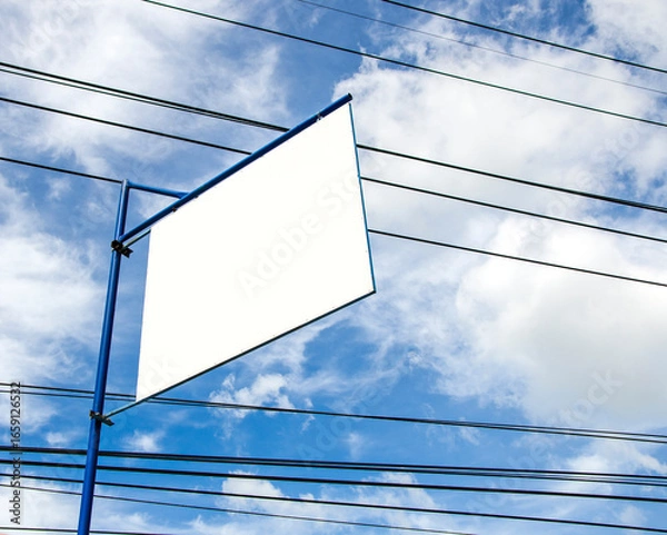 Fototapeta Blank advertisement board on blue sky with messy power cords 