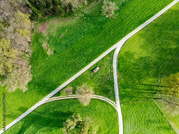 Obraz Aerial view of rural road through countryside meadows and farmland in Canton of Fribourg in Switzerland. 