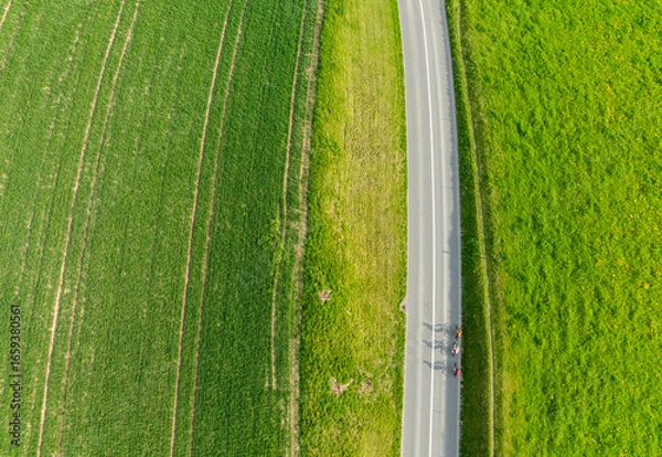 Obraz Aerial view of rural road through countryside meadows and farmland in Canton of Fribourg in Switzerland. 