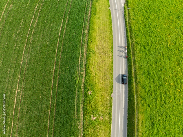 Obraz Aerial view of rural road through countryside meadows and farmland in Canton of Fribourg in Switzerland. 