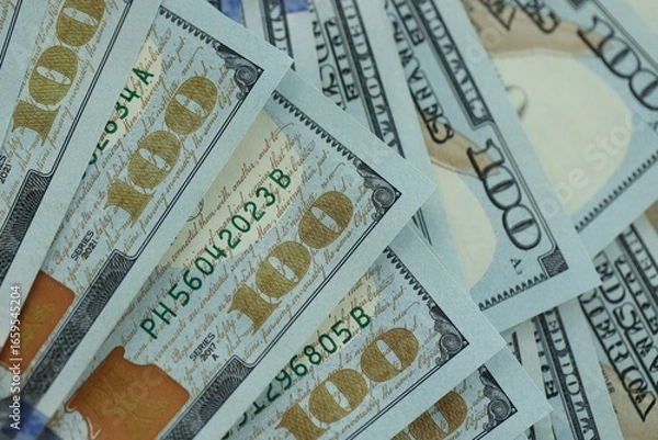 Fototapeta Many hundred dollar bills new banknotes in big pile under the natural light