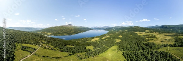 Fototapeta Expansive panoramic aerial view showcases Gjevilvatnet lake surrounded by the majestic Trollheimen and Innerdalen mountain range, highlighting natural beauty and serene landscapes in Oppdal, Norway