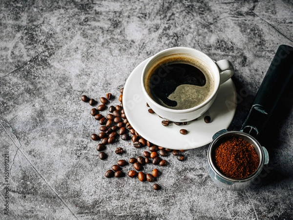 Fototapeta Coffee cup and beans with ground coffee on Portafilter,Top view Espresso coffee cup aromatic and making equipment